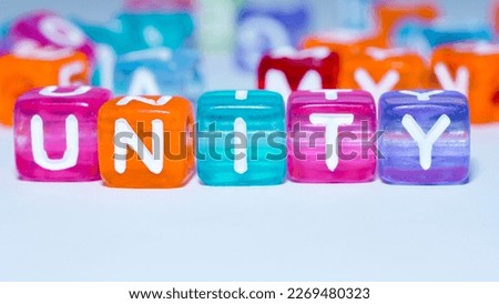 Macro photo of the word "unity" on a colorful cube. fun concept about unity. inscription on the cubes. education sign series for education and learning