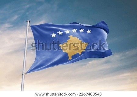 Waving flag of Kosovo in beautiful sky. Kosovo flag for independence day. The symbol of the state on wavy fabric.