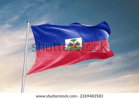 Waving flag of Haiti in beautiful sky. Haiti flag for independence day. The symbol of the state on wavy fabric.