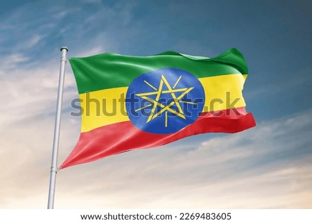 Waving flag of Ethiopia in beautiful sky. Ethiopia flag for independence day. The symbol of the state on wavy fabric.