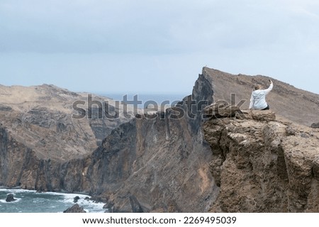 madeira sea rock view summer travel tourism vacation clif geology nature mountain peak woman take picture selfie