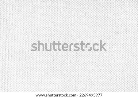 Close-up texture of natural white coarse weave fabric or cloth. Fabric texture of natural cotton or linen textile material. White canvas background. Decorative fabric for upholstery, furniture, walls Royalty-Free Stock Photo #2269495977