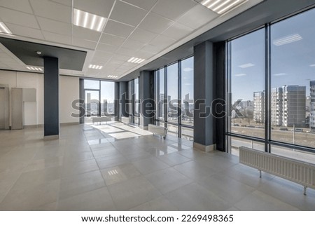 panorama view in empty modern hall with columns, doors and panoramic windows. Royalty-Free Stock Photo #2269498365