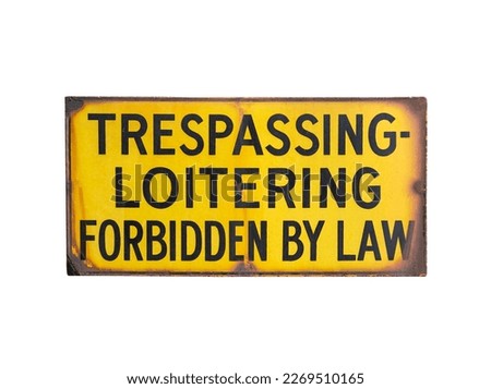 Rusty old trespassing and loitering forbidden by law sign.  Isolated with cut out background.
