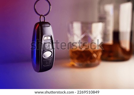 Car keys with glass and bottle of liquor, don't drink and drive concept Royalty-Free Stock Photo #2269510849