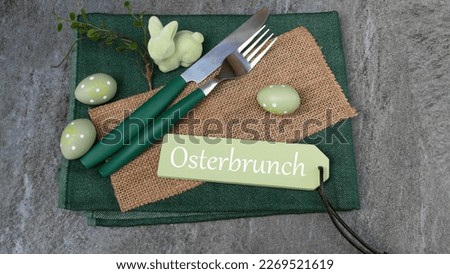 Label with the inscription Osterbrunch with cutlery and Easter decoration.German inscription means Easter brunch.