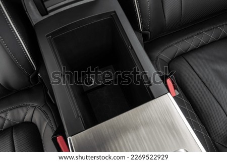 Car armrest opened. Opened armrest in the car for driver. Royalty-Free Stock Photo #2269522929