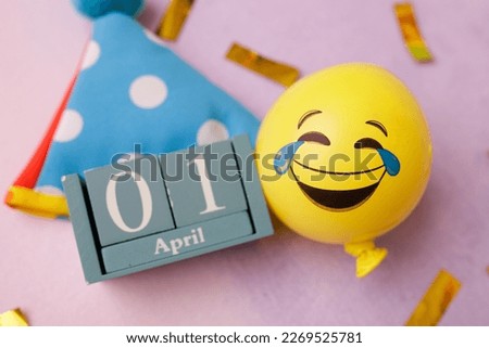 date April 1. Creative concept for April Fools' Day. Festive decor on the blue background.