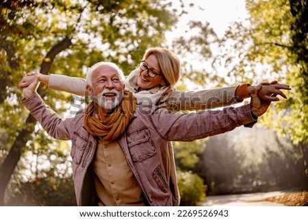 Cheerful pensioners enjoying their life together having fun outdoors in the park Royalty-Free Stock Photo #2269526943