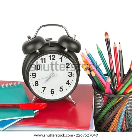 School supplies and alarm clock isolated on white background. Concept - Back to school.