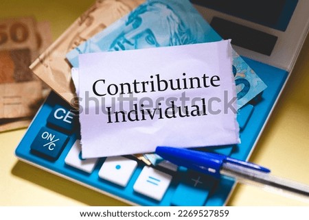 The text individual contributor in Brazilian Portuguese written on a piece of paper. Brazilian Real banknotes in the composition. Annual income tax return.
 Royalty-Free Stock Photo #2269527859