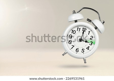 Change time. Summer time concept, on a wooden background. A white alarm clock with a minute hand indicates that the time has been moved forward an hour with copy space. Royalty-Free Stock Photo #2269531961