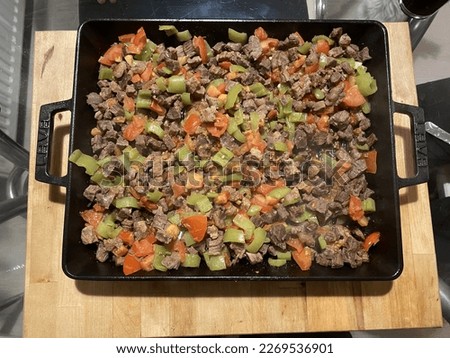 Sizzling Steak and Vegetables: A Flavorful Dish Cooked in a Granite Pan