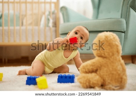 Cute little baby boy, playing at home, crawling