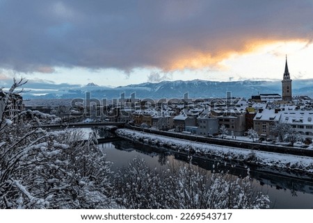 View of the Austrian city of Villach in the federal state of Carinthia, against the backdrop of the snow-capped Alps, the Karawanken ridge, at sunset Royalty-Free Stock Photo #2269543717
