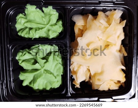 Ginger and wasabi for sushi in a container close-up.