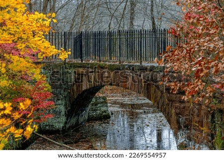 Walking Path Bridge in Autumn. Part of both the Lock 12 park and the linear trail or "rails to trails" in Cheshire, CT. A super peaceful environment with great views everywhere. Royalty-Free Stock Photo #2269554957