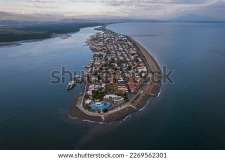 Beautiful aerial view of Puntarenas  beach and Town, its lighthouse and shores at sunset with palm trees
