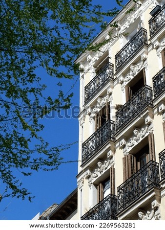 Corner of vintage house in downtown district of Madrid, Spain. Authentic Spanish architecture. Vertical photo.