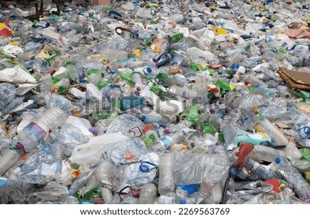 A bunch of empty plastic bottles in a landfill Royalty-Free Stock Photo #2269563769