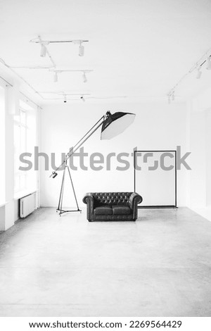 Interior of a photo studio. Leather sofa and studio equipment
