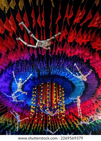 Skeletons flying in the air against the background of colorful ornaments