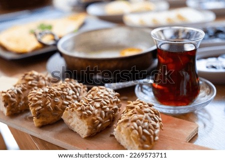 Sunflower seed bagel and Turkish tea, breakfast. Known as Turkish simit and tea.