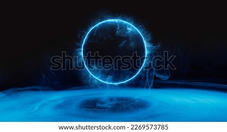 Neon blue color geometric circle on a dark background. Round mystical portal. Mockup for your logo. Futuristic smoke. Abstract image of dark room concrete floor.