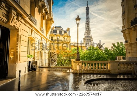 cosy Paris street with view on the famous Eiffel Tower on a cloudy summer day, Paris France, retro toned Royalty-Free Stock Photo #2269574017