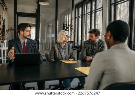 Shot of business persons filling in paperwork in the office. Businessman and businesswoman signing a document in the board room.