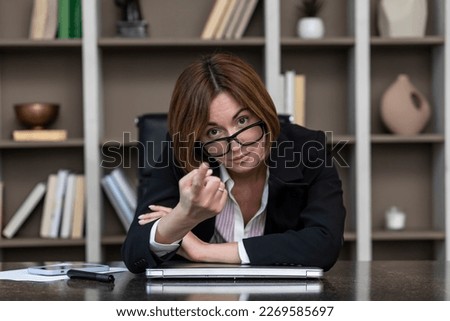 Serious business woman in black suit working in modern office