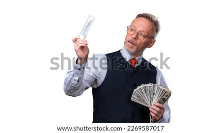 Happy elderly business man with fan of dollar bills isolated on white background. Senior man guy won the lottery, lucky day. Human emotions and facial expressions.