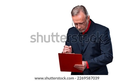 Middle aged businessman standing and holding file folder. Checking notes. Horizontal format isolated on white background.