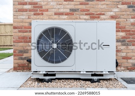 Air Source heat pump fitted outside a new home development Royalty-Free Stock Photo #2269588015