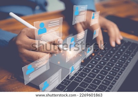 The human resource manager is recruiting employees. Checks the CV online to choose the perfect employee for his business. The human resources system is digital and online. Royalty-Free Stock Photo #2269601863