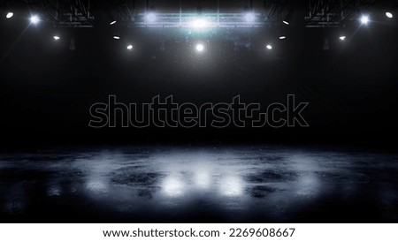 Blue ice floor texture and mist. Snow and ice background. Empty ice rink illuminated by spotlights. Scene Illumination Royalty-Free Stock Photo #2269608667