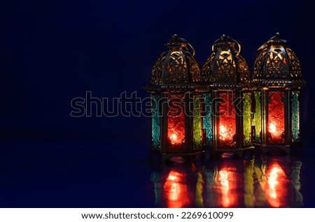 Lanterns put on table with dark blue background for the Muslim feast of the holy month of Ramadan Kareem.
