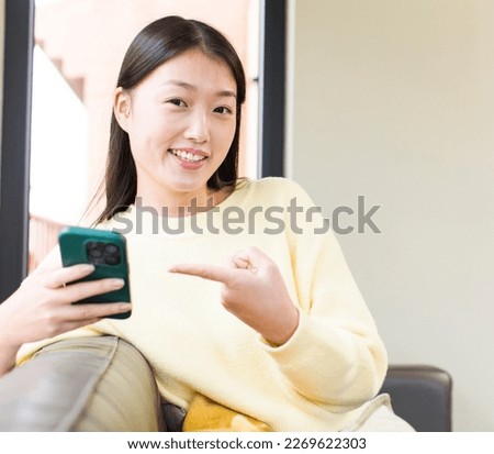 asian pretty woman using a smartphone and shopping at home
