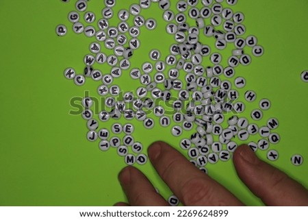 Beads with letters on them on backgrounds