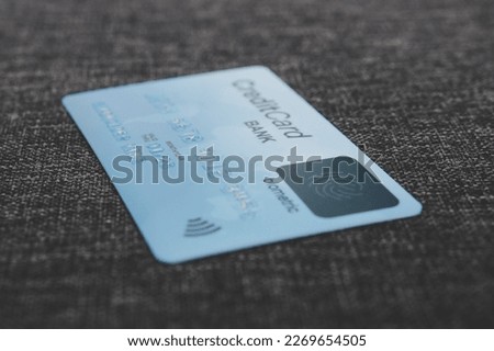 Credit card with fingerprint sensor in blur style. Close up of biometric credit card lying on the flooring. Using safe and simple way to pay online for purchases. Fingerprint scanning in banking