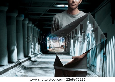 person holding a square frame with a backround painting, surreal creative concept  Royalty-Free Stock Photo #2269672235