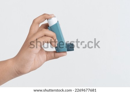 Asian boy hand holding asthma inhaler on white background with space for text Royalty-Free Stock Photo #2269677681