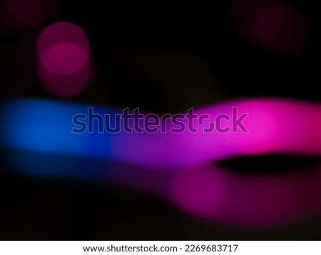 Blurred pink light lines for an abstract dark toned background.