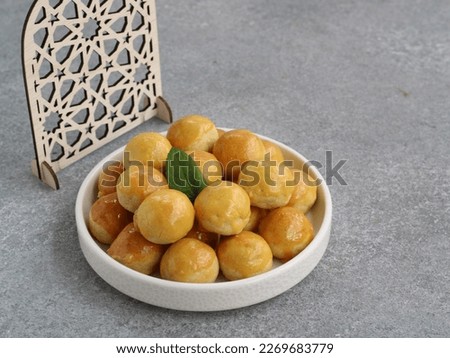 Nastar or pineapple tart cookies is the rich buttery shortcrust pastry with homemade sweet pineapple jam as the filling. this cookies usually served during Eid celebration. selected focus  Royalty-Free Stock Photo #2269683779