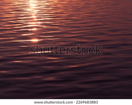 Golden sunlight reflecting on water surface before sunset for peace concept abstract background.