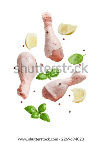 Raw flying chicken drumstick And spices cut out on a white background Royalty-Free Stock Photo #2269694023