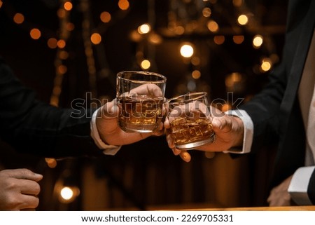 Celebrate whiskey on a friendly party in restaurant Royalty-Free Stock Photo #2269705331