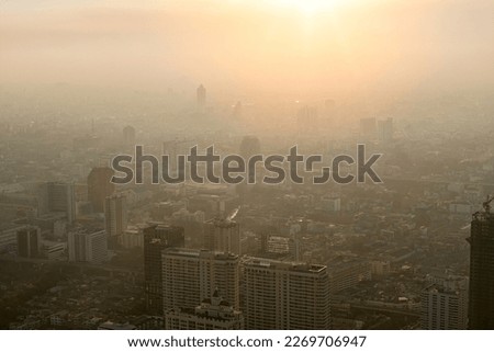 Bad air pollution in City. PM 2.5 dust in Bangkok or center city, Capital city are covered by heavy smog, Misty morning and sunrise in downtown with bad air pollution, Place to risk of cancer,Thailand Royalty-Free Stock Photo #2269706947