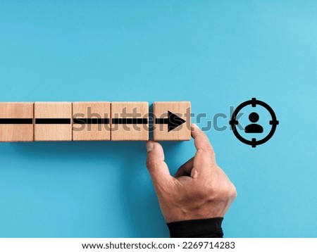 Target customer and buyer persona. Business market segmentation. Personalization marketing and customer centric strategies. Wooden blocks with the arrow moving towards the target customer symbol. Royalty-Free Stock Photo #2269714283