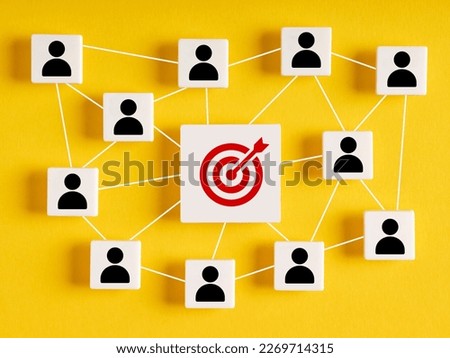Teamwork and collaboration in goal achievement in business. Brainstorming for finding ideas. Cubes with network of employees and target goal icons on yellow background. Royalty-Free Stock Photo #2269714315